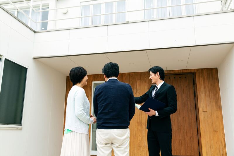 一戸建てを紹介するスタッフ